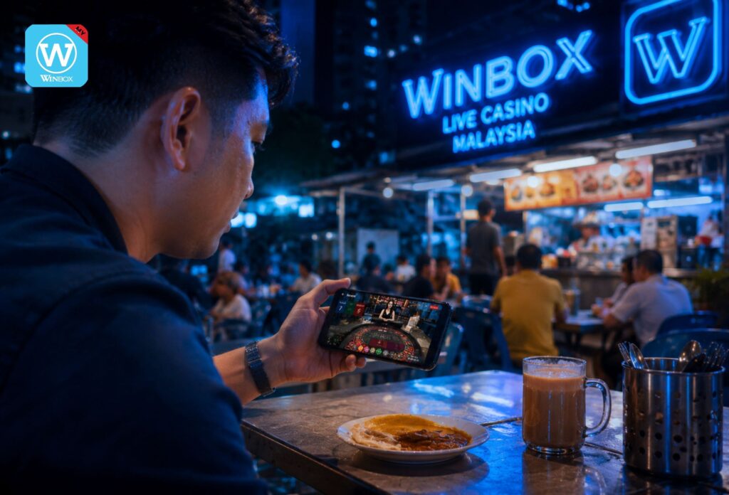 Live Casino Malaysia 17 Malaysian player enjoying live roulette on Winbox mobile casino at mamak stall at night